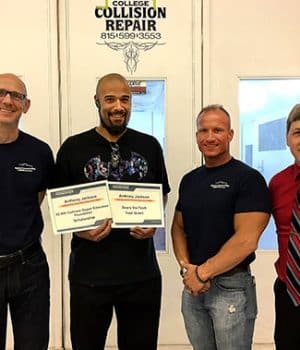 Anthony Jackson with award and auto students