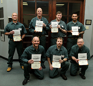 Photo of The Thomson Cohorts pose with their certificates after a graduation ceremony