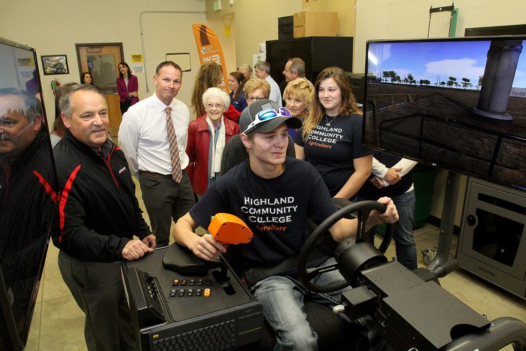 highland agriculture student using tractor simulator with faculty observing