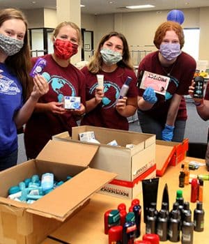 High school students pose with personal item donations