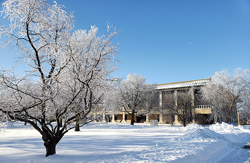 building M is shown with snow covering the ground and trees