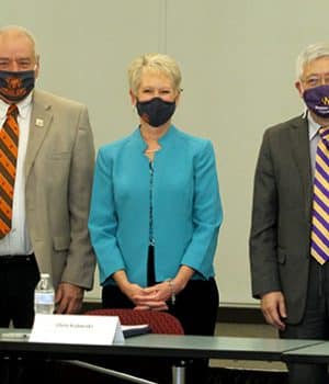 HCC president and board chairman stand with the WIU president