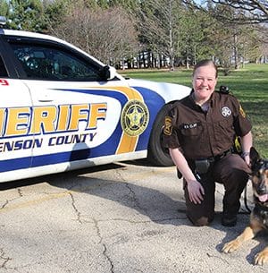 Rachel Clay and K9 Ralf pose with her squad car