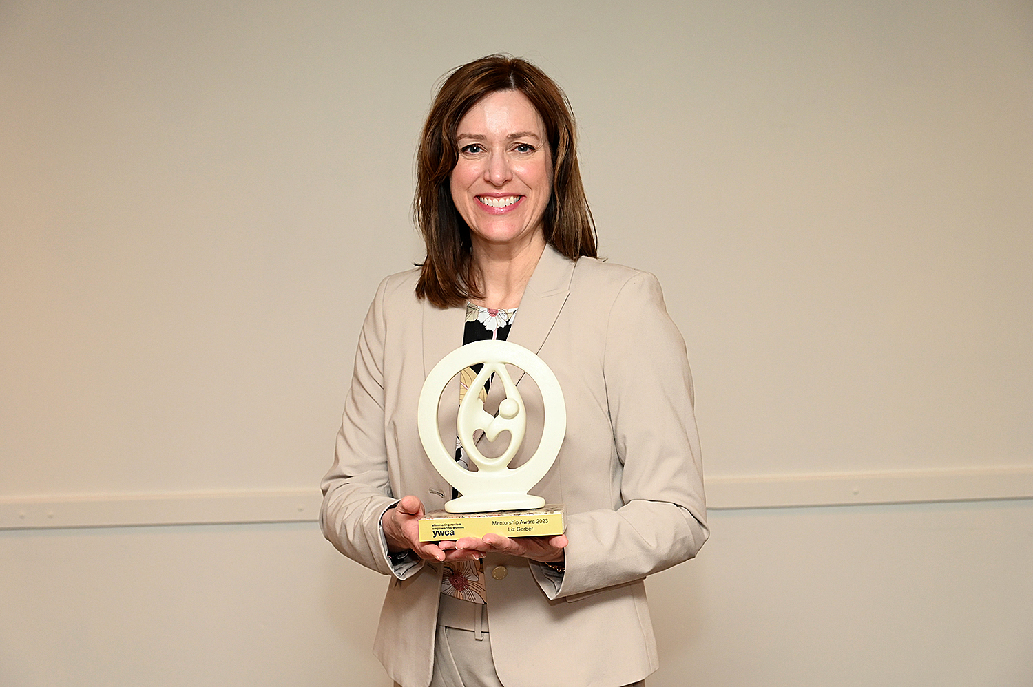 Liz Gerber holding the Mentorship Award