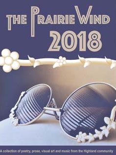 The Prairie Wind 2018 Cover shows a an image of sunglasses reflecting sunlight through the slats of blinds, edged in a flower vine.
