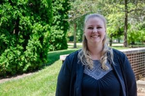 Smiling woman standing on campus