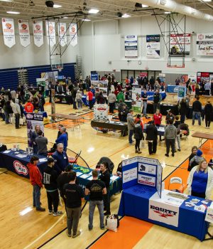 A group of students and industry empoyers gather in the Highland Sports Complex/YMCA gym.