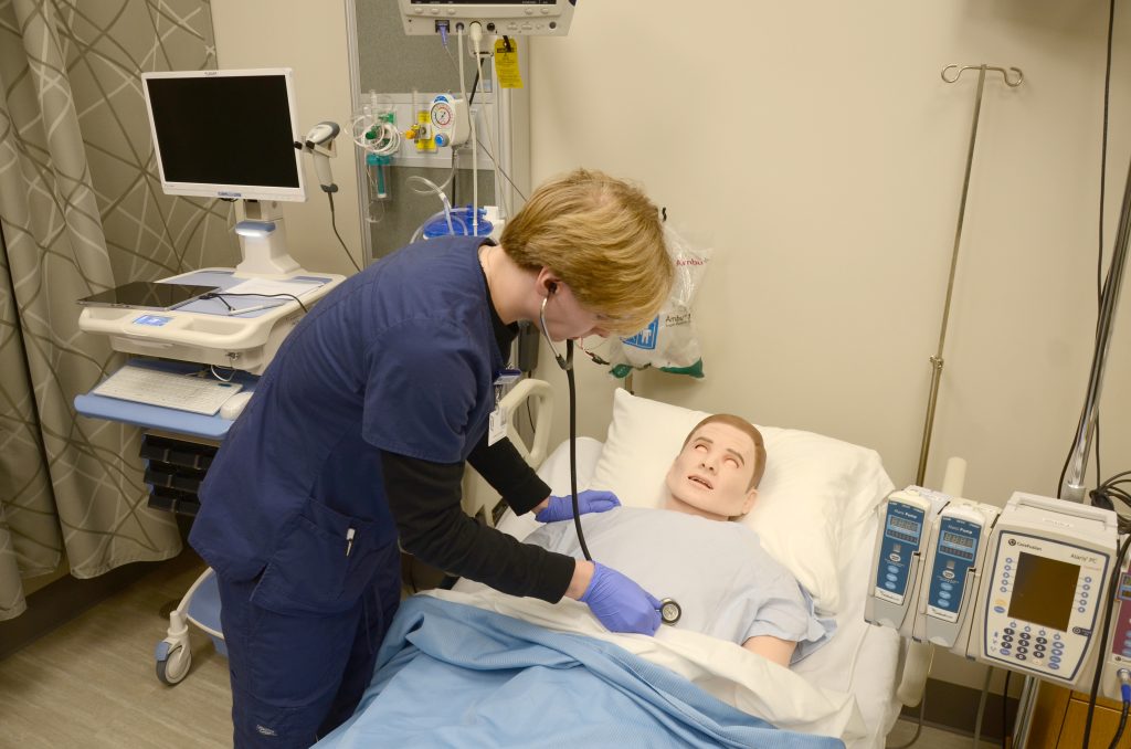 Student practicing medicine on a dummy patient