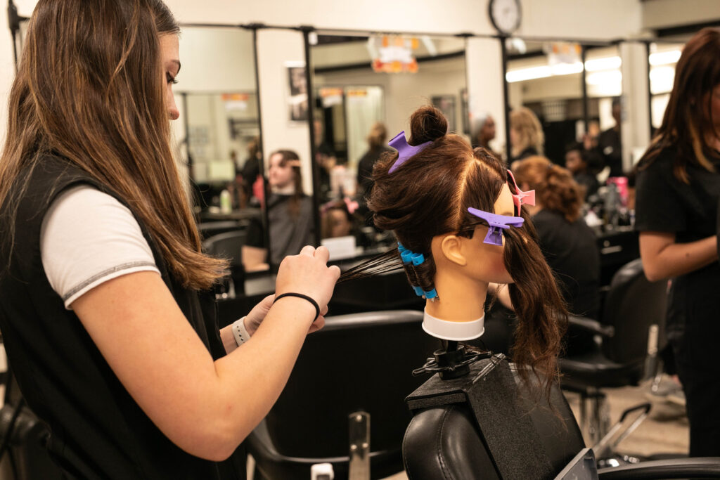 Highland cosmetology student working on hair techniques. 
