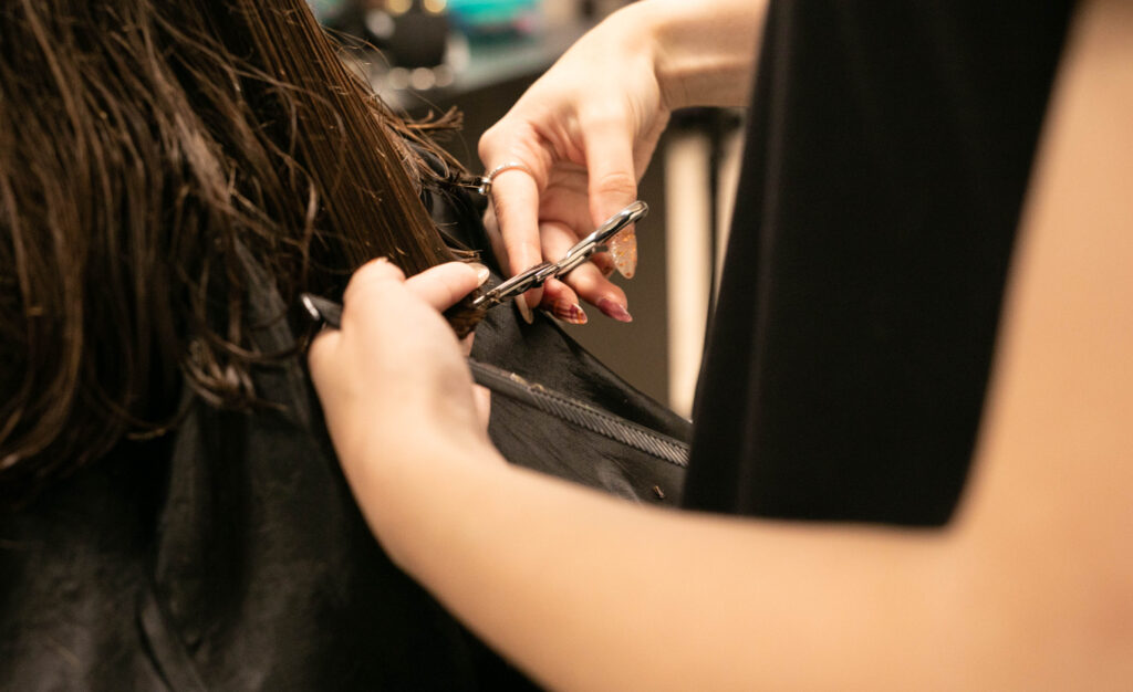 Someone getting their hair cut at Highland Community College's Cosmetology department. 