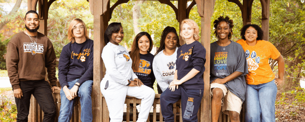 Diverse group of students in an outside gazebo.