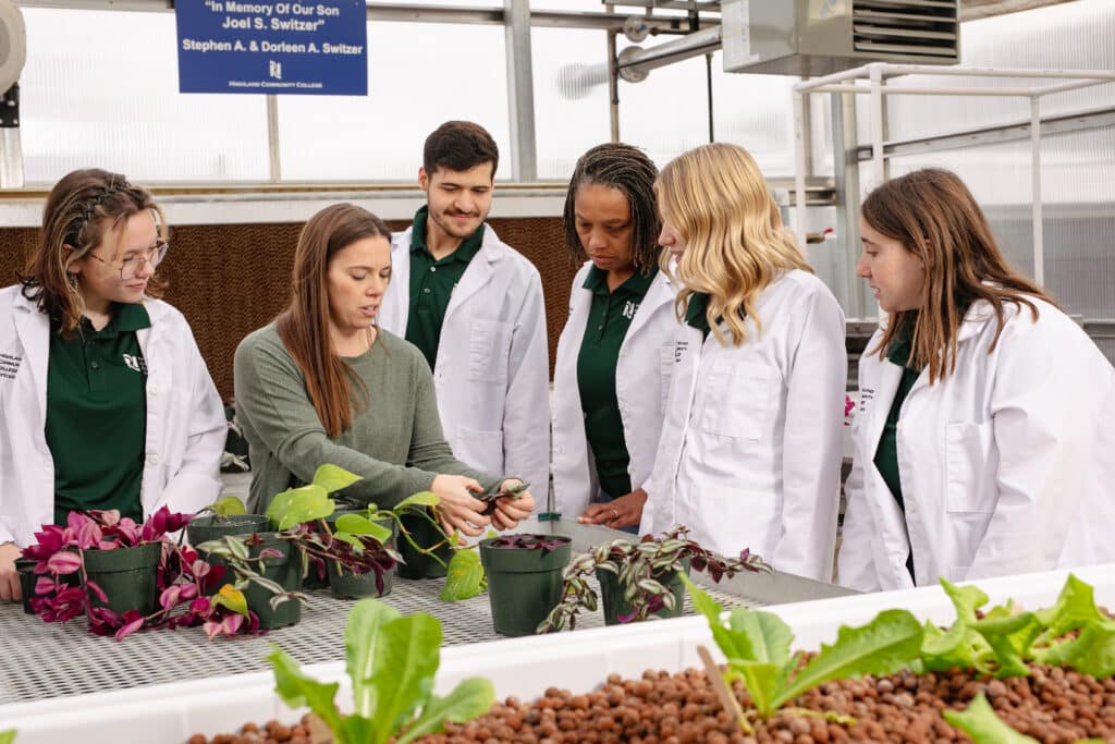 horticulture students and teacher cutting plant clones