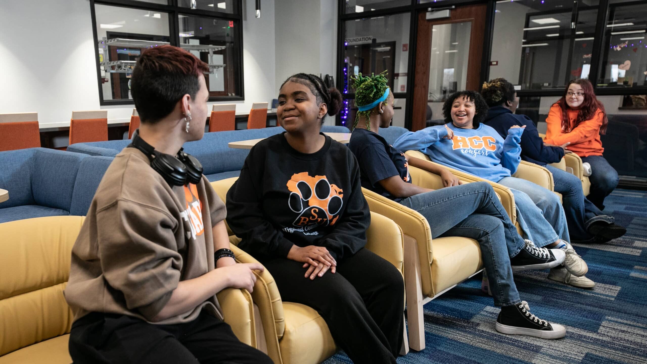 Four students sitting in the welcome center