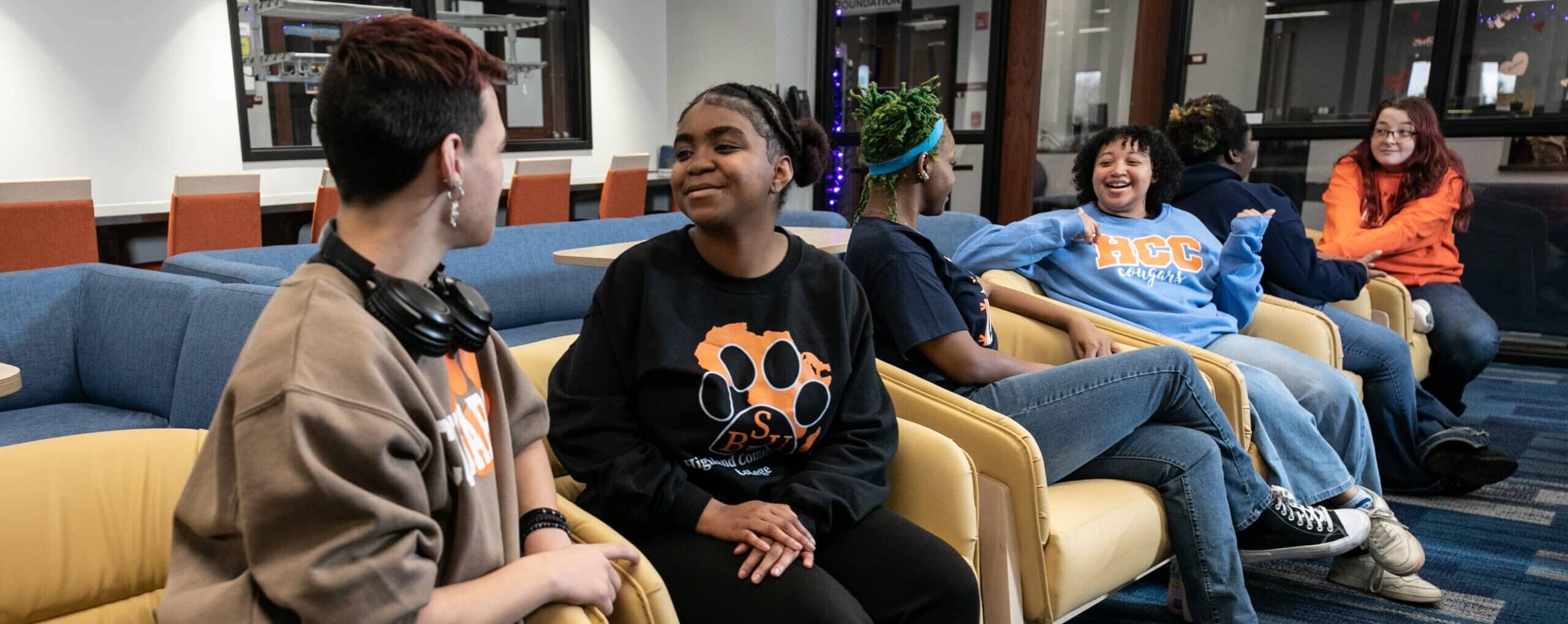 Four students sitting in the welcome center