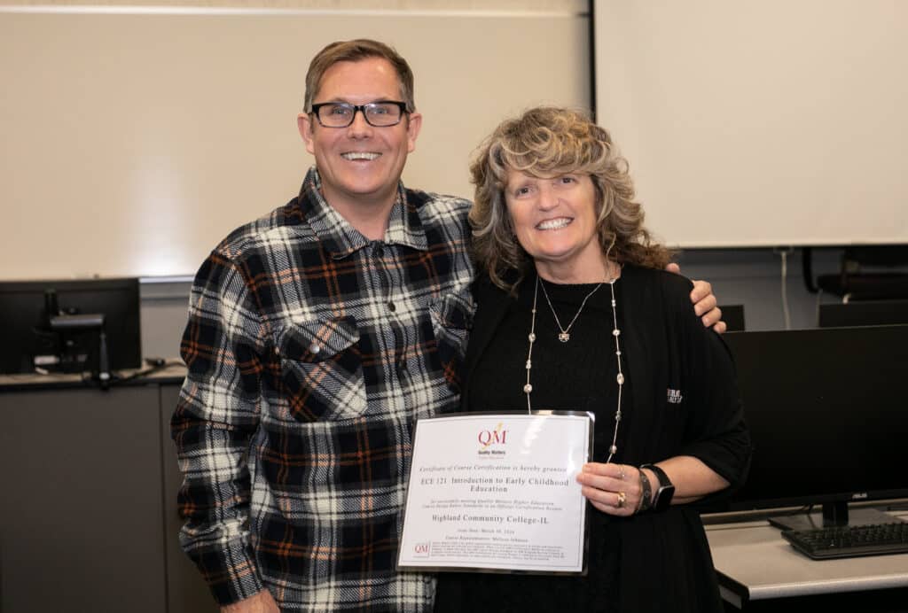 Instructor standing with faculty instructor holding a certificate.
